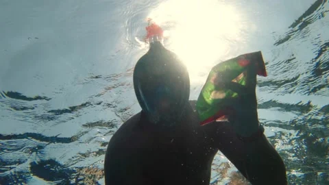 Garbage collection in the sea or ocean. man, wearing a snorkeling mask, swims Stock Footage 143779502
