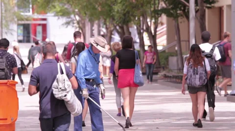 Garbage collector in a crowded walk way Stock Footage 32154088