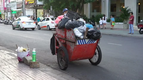 Garbage collector in uniform is working on a roadside of the street Stock Footage 66273551