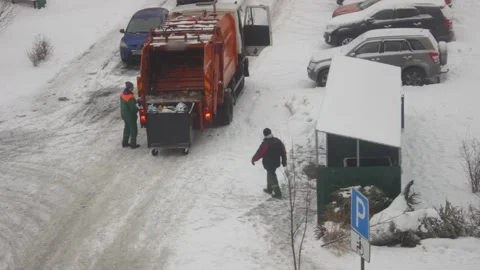 Garbage collectors load waste from container into truck Stock Footage 147732376