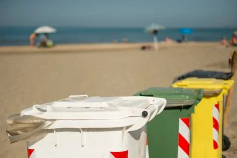Garbage color coded bins on beach Stock Photos