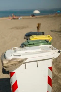Garbage color coded bins on beach Stock Photos