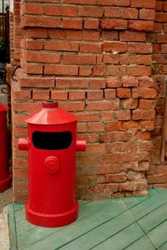 The garbage container is metallic red in a loft-style space on the street Photos