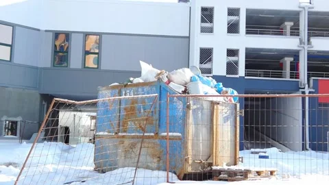 Garbage container in winter near a building in a snowy area during the daytime Stock Footage 328438286