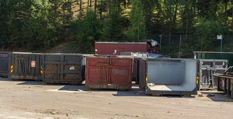 Garbage containers for auto-bottles stand on the territory of the processing Stock Photos