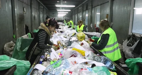 Garbage containers. Heaps of plastic, cellophane. People sort the garbage by Stock Footage 156078425