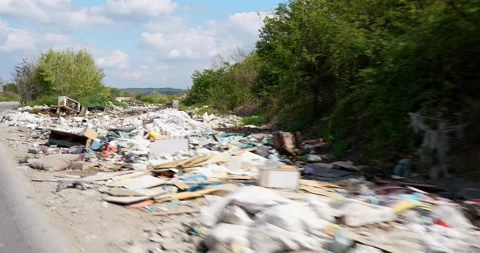 A garbage dump along the road that people have dumped and pollute nature Video stock 182362974