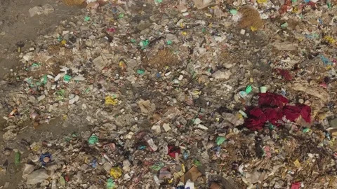 A Garbage dump on the banks of the Saloum River, Kaolack- Senegal Stock Footage 165358692