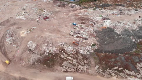 Garbage dump. Bulldozer is pushing debris on field. Construction waste pours out Stock Footage 141293088