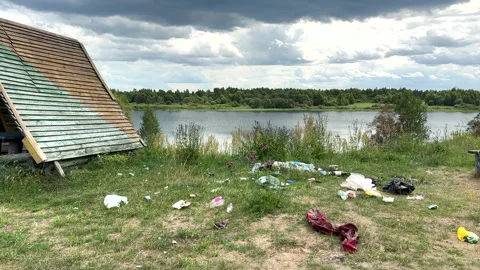 Garbage dump in Illegal location. People throw garbage near lake Stock Footage 252102435