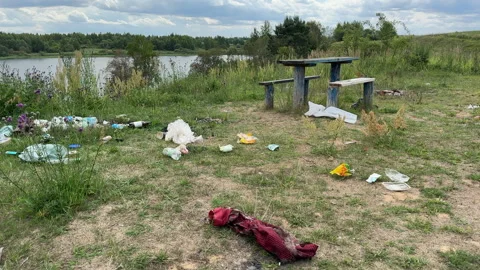 Garbage dump in Illegal location. People throw garbage near lake Stock Footage 252102953