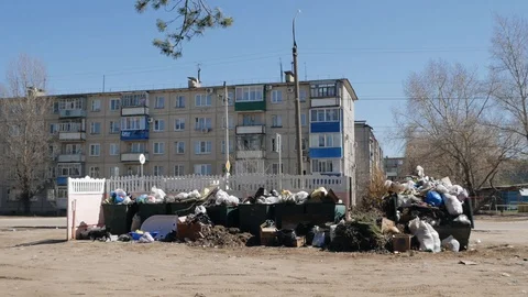 Garbage dump in a large tank near a residential building. Stock Footage 130077357