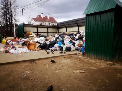 Garbage dump. Overcrowded dumpsters. Mixed waste. Stock Photos