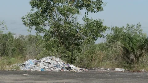 Garbage dump on the roadside of rural coutry road Stock Footage 157804765