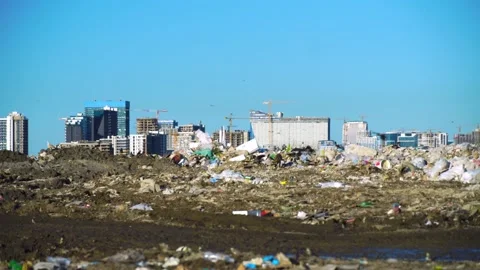 Garbage dump. Skyscrapers, construction site with crane and houses of big city 動画素材 164316329