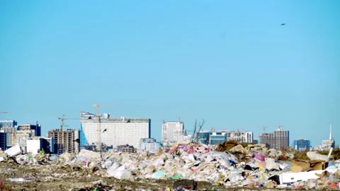 Garbage dump. Skyscrapers, construction site with crane and houses of big city 動画素材 164316500