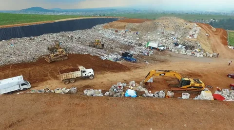 Garbage Dump Trucks and Dozers Working Stock Footage 65158116