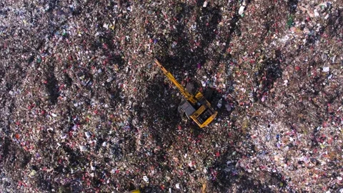 Garbage dump with unsorted plastic. Excavator working on the top of waste pile Video stock 295955468
