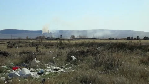Garbage dump, waste dump in the field against the background of Smoking pipes. Vídeos de archivo 132934457
