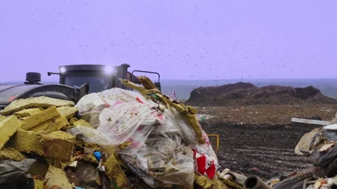 Garbage dump with waste plastic and food waste. Bulldozer at landfill working. Stock Footage 231688150