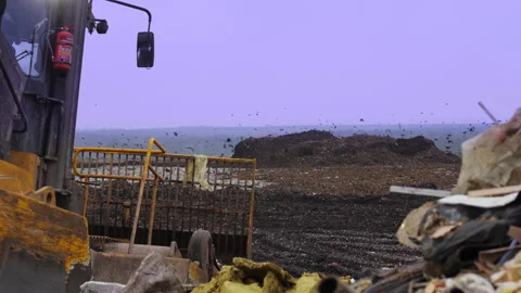 Garbage dump with waste plastic and food waste. Bulldozer at landfill working. Stock Footage 232172218