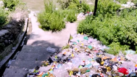 Garbage Dumped Near River Causing Water Pollution Vidéo 339533359