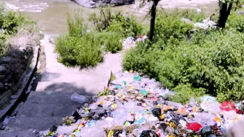 Garbage Dumped Near River Causing Water Pollution Stockbeeldmateriaal 339533413