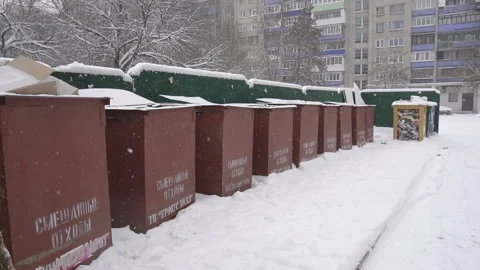 Garbage dumping bins in the yard, it is snowing, winter, background, pollution Stock Footage 117185590