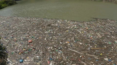 Garbage floats in water. Plastic bottles, boards on water surface. Ecology Stock Footage 193997036