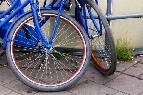 Garbage in the form of cigarette waste under the wheels of bicycles Stock Photos