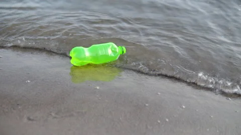 Garbage in the form of a plastic bottle floats in the river, lake close-up Stock Footage 142589188