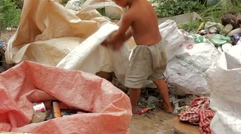 Garbage gatherers assorting trashes in slums Stock Footage