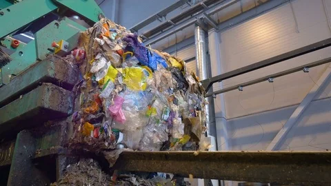 Garbage get stacked into blocks at a recycling plant. Timelapse Stock Footage 73025011