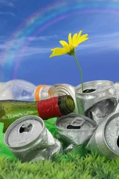 Garbage with growing daisy under rainbow Stock Photos