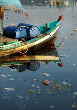 Garbage in the harbor water. Stock Photos