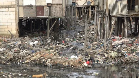 Garbage has been dumped in shallow stream in slums of Jakarta, Indonesia Video stock 78572428