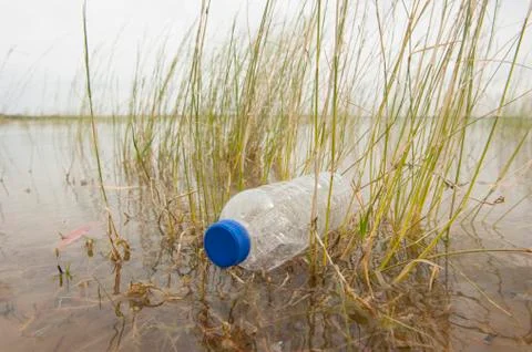Garbage junk dumped in water Stock Photos