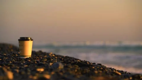 Garbage left on empty beach with sea in background Stock Footage 133376282