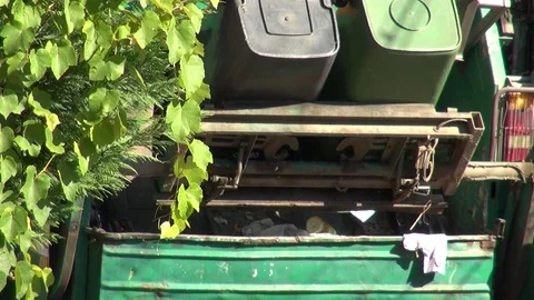 Garbage men loading household waste from bins into garbage truck Stock Footage 83242410