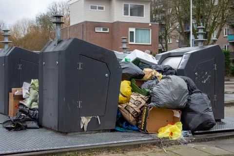 Garbage men striking making the underground garbage cans overflow Stock Photos