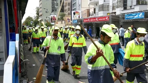 Garbage men walking in the streets of Tehran to clean after a national march Video stock 70878648
