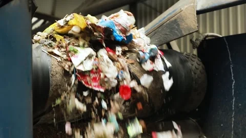 Garbage moves and falls from the conveyor at waste disposal factory Stock Footage 246771157
