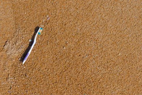 Garbage, old toothbrush garbage the beach, sea water pollution with old too.. Stock Photos
