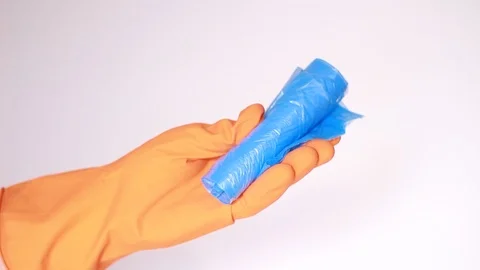 Garbage package in hand in orange rubber glove Vídeo Stock 97864679