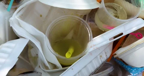 Garbage pile, Disposable plastic cups and containers highlighting pollution Stock Footage 336395093