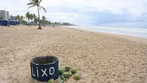 Garbage piled up on the sand of the beach Stock Photos