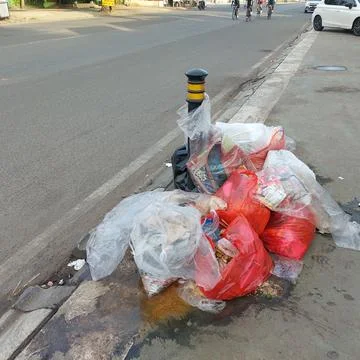 Garbage piled up on the side of the road Stock Photos