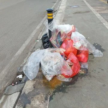 Garbage piled up on the side of the road Stock Photos