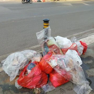 Garbage piled up on the side of the road Stock Photos