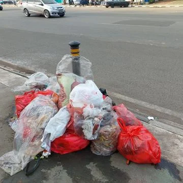 Garbage piled up on the side of the road Stock Photos